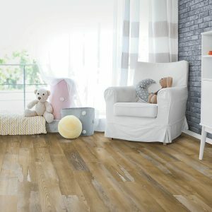 Flooring laminates in the kid's room with a white love seat