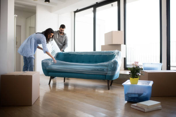 Couple moving sofa | Brian's Flooring & Design